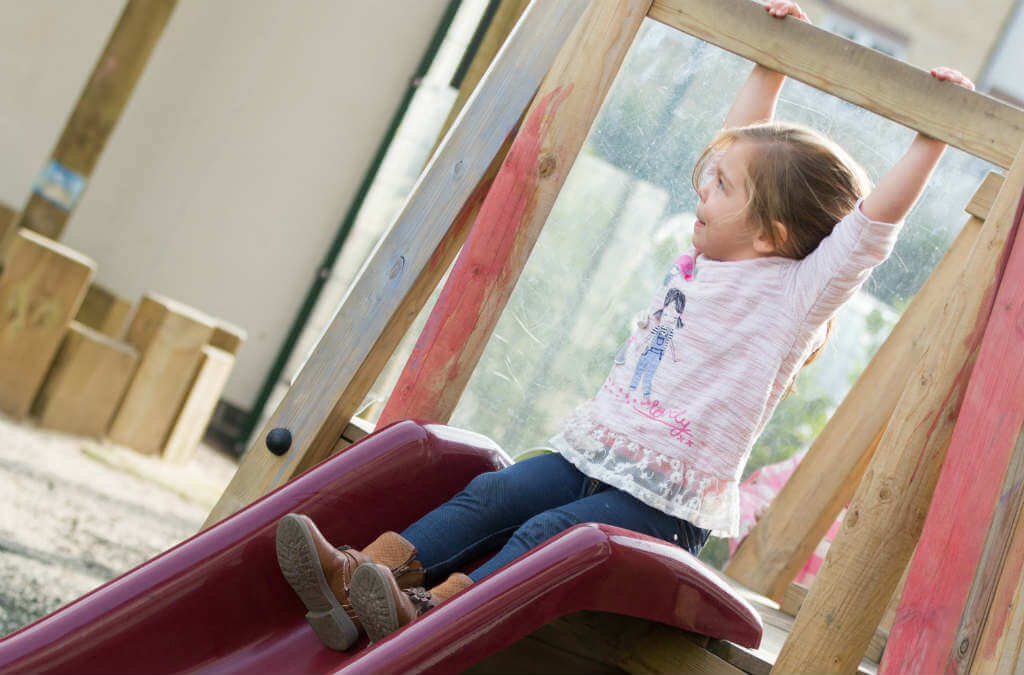 Child going down slide