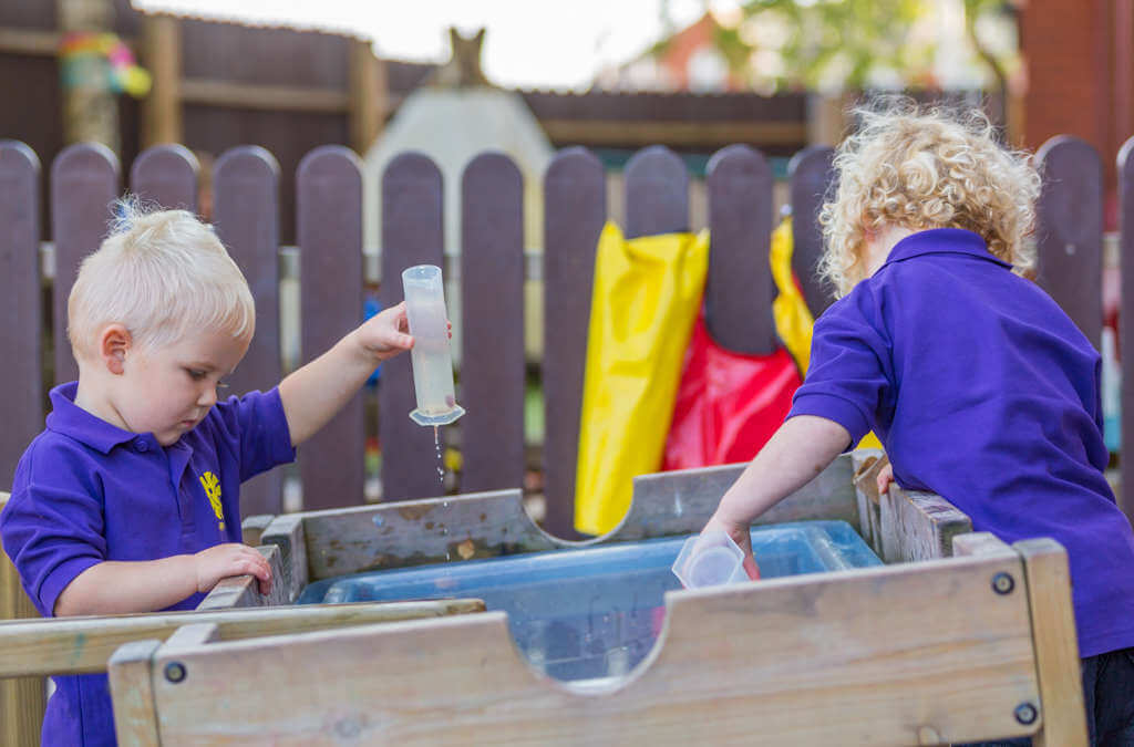 Children playing outdoors with water