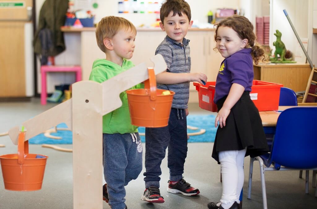 Children playing in a group indoors